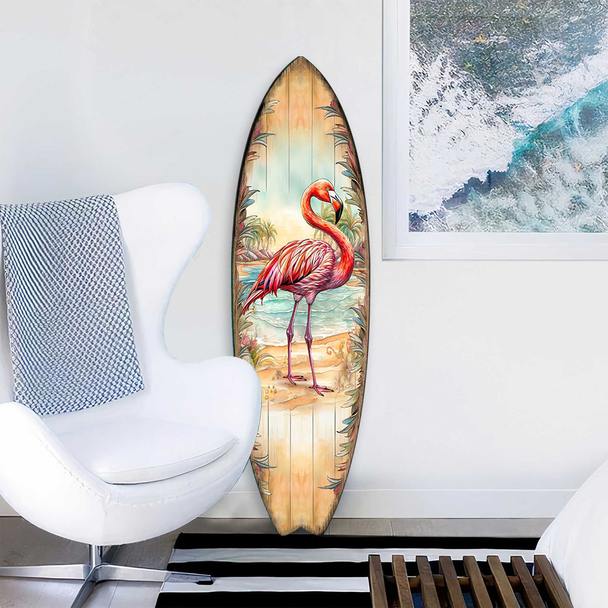 Pink flamingo surfboard wall art styled in a coastal room